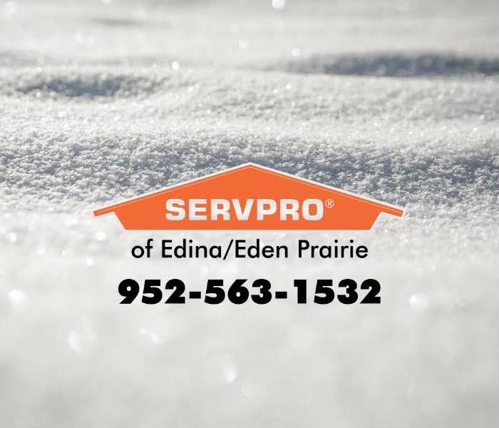 A blanket of snow with an orange SERVPRO logo.